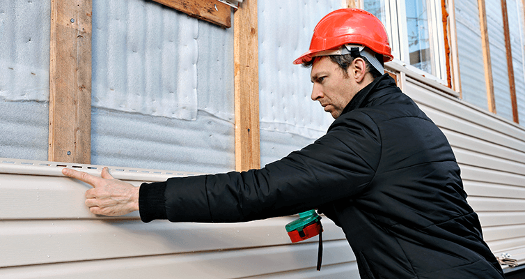 Man Working On Siding
