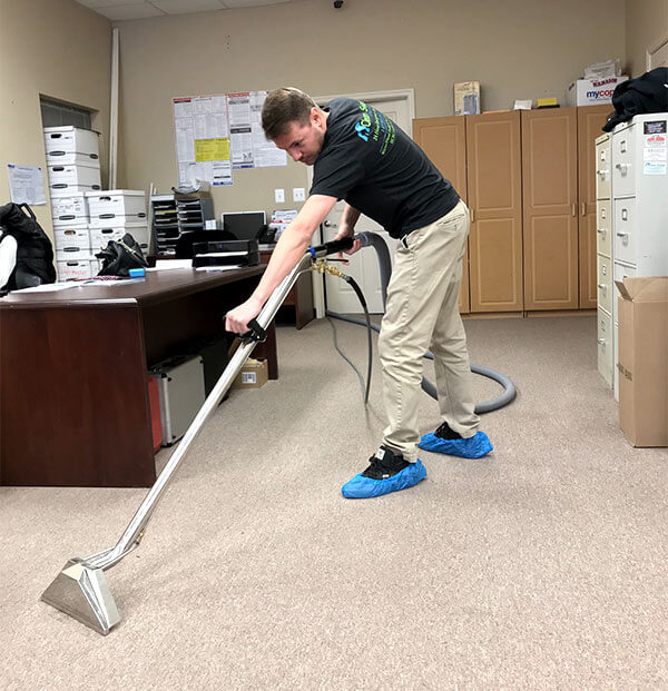Clean Sweep technician vacuuming. Westminster, MD Office Cleaning