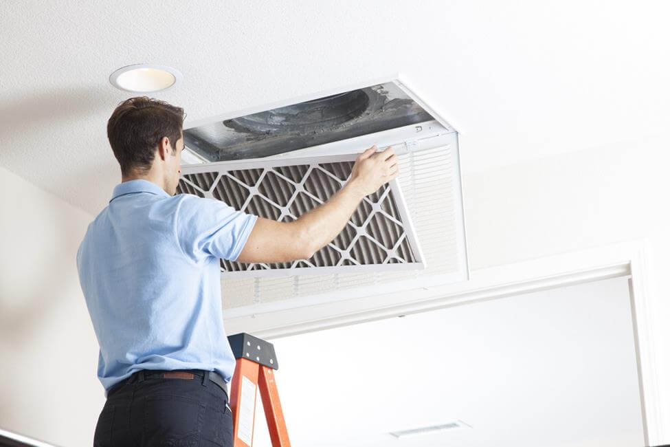 Man Changing Air Filter Indoor Air Cleaning - Changing Your Air Filter Removes Mold Spores and Other Pollutants