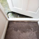 flood water at doorway to home