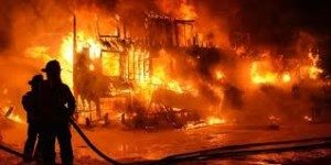 firefighter putting out fire on home image