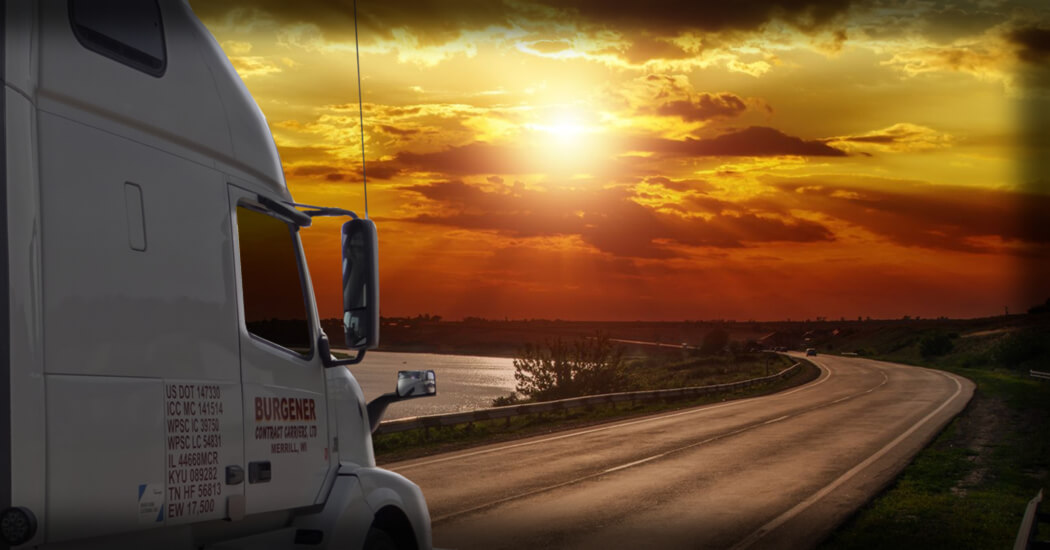 Burgener Contract Carriers, LTD truck driving into sunset.