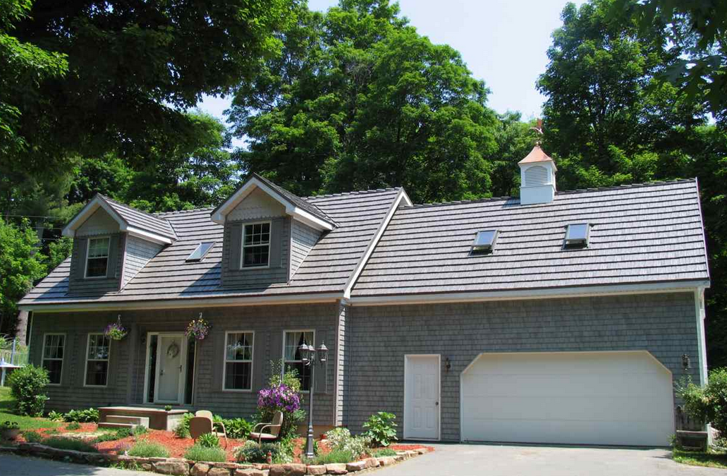 two-story home with grey steel shake roofing