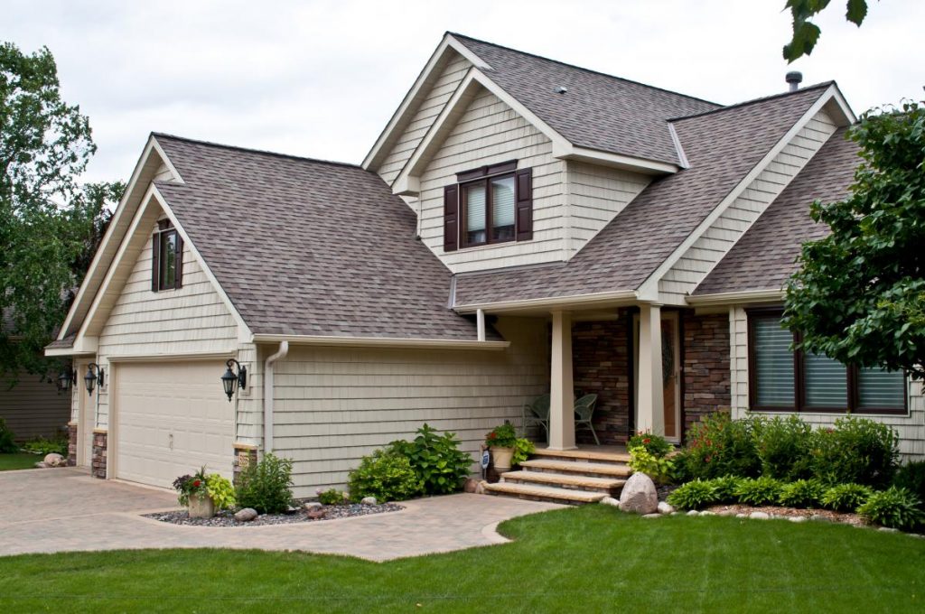 two-story tan home with steel shake siding