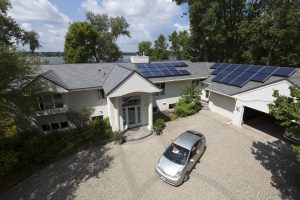 Aerial view of home with metal roofing and solar panels