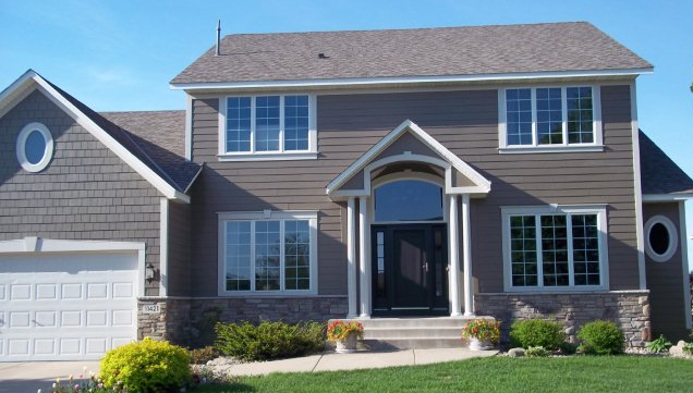 Front of 2-story dark tan home with seamless steel siding