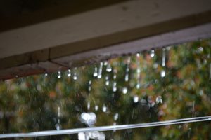 Closeup of roof overhang showing dripping rain