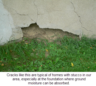 closeup of damaged stucco on home at foundattion