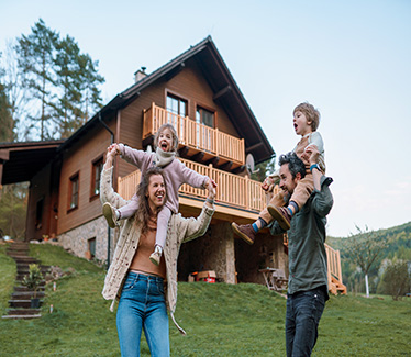 Family outside restored home