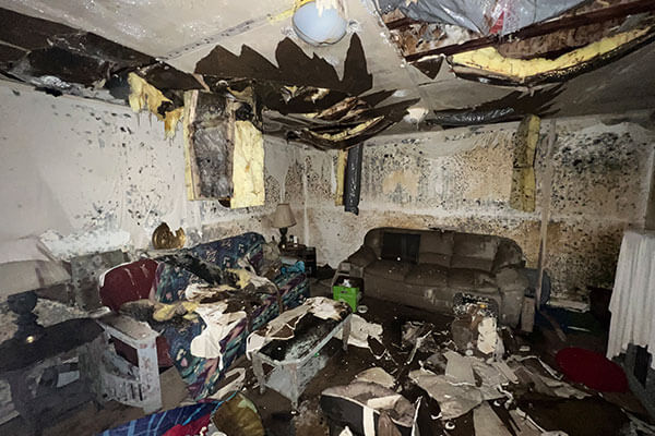 Commercial mold remediation scene showing heavy interior damage and contamination in a restored room
